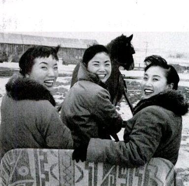 ON A SLEIGH, the three Kim sisters start off for a horse-drawn tour of the snow-covered farm. From the left are Sook Ja, Ai Ja and Min Ja.