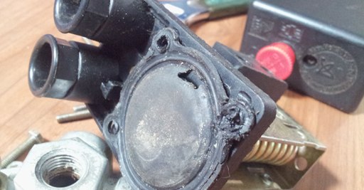 Disassembled pressure switch exposed ugly 'teared' diaphragm 